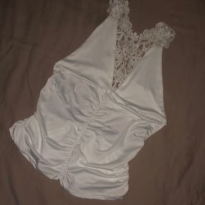 Silky backless tank top with strappy lace on back.